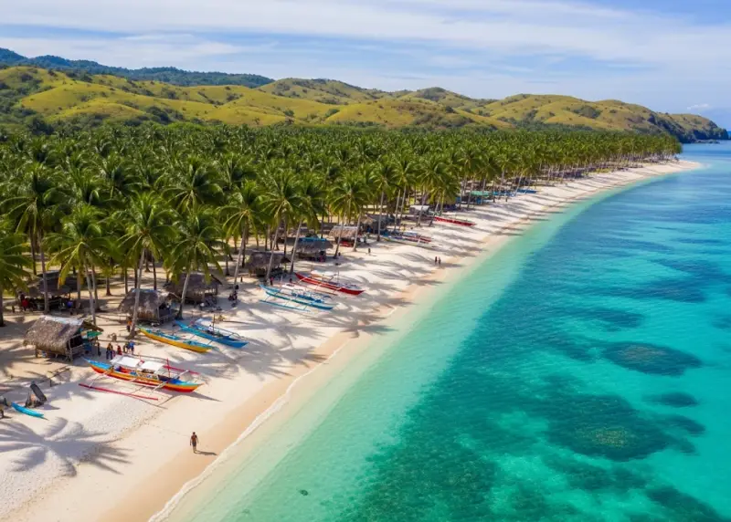 calaguas islands camarines norte Aerial view of Calaguas Islands in Camarines Norte showing long white sand beach, turquoise waters, and grassy hills.