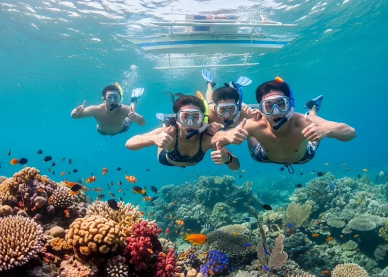coron siete pecados snorkeling friends Friends snorkeling together at Siete Pecados Marine Park surrounded by corals and fish.