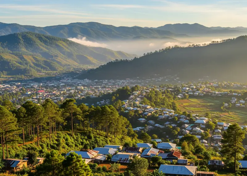 malaybalay city highlands view Panoramic view of Malaybalay City with pine-covered mountains and mist.