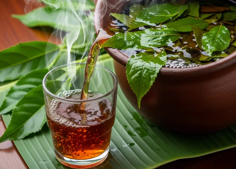 tsaang gubat herbal medicine doh Tsaang Gubat herbal tea freshly brewed in a clay pot and poured into a glass.