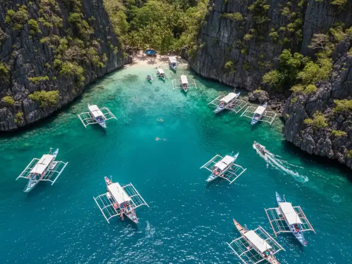 el nido bacuit bay island tours Aerial view of tour boats scattered across Bacuit Bay in El Nido.