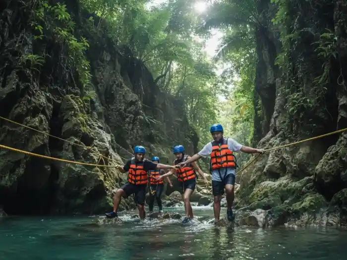 kawasan falls canyoneering trail experience badian cebu Filipino adventurers trekking through turquoise rivers during Kawasan Falls canyoneering.