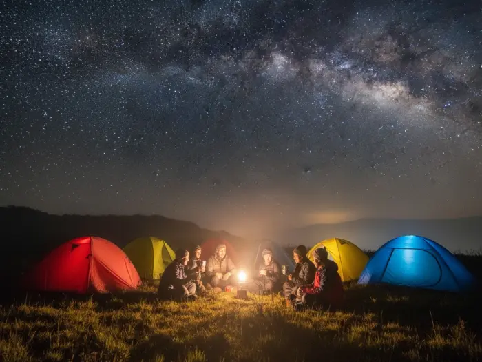 mount pulag camping tents overnight tips Filipino hikers camping at Mount Pulag under the stars with tents and warm jackets.