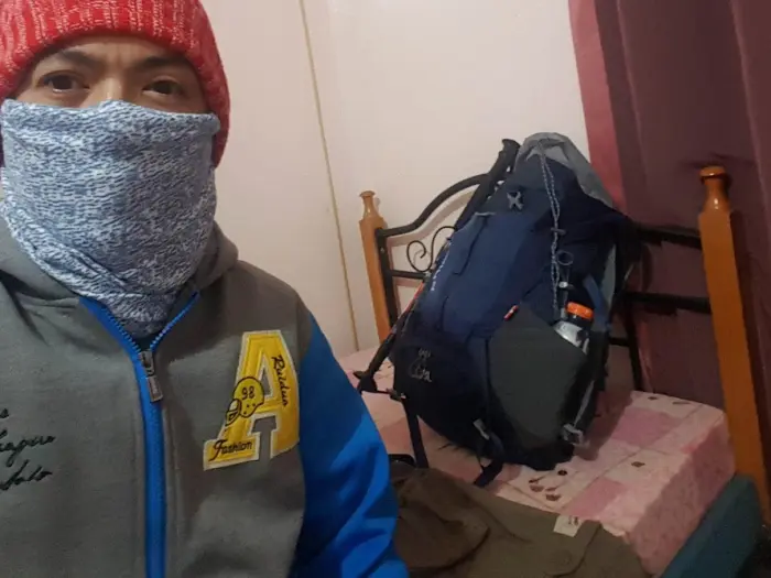 mount pulag packing list cold weather gear Filipino hiker preparing winter gear and essentials for Mount Pulag’s cold-weather hike.