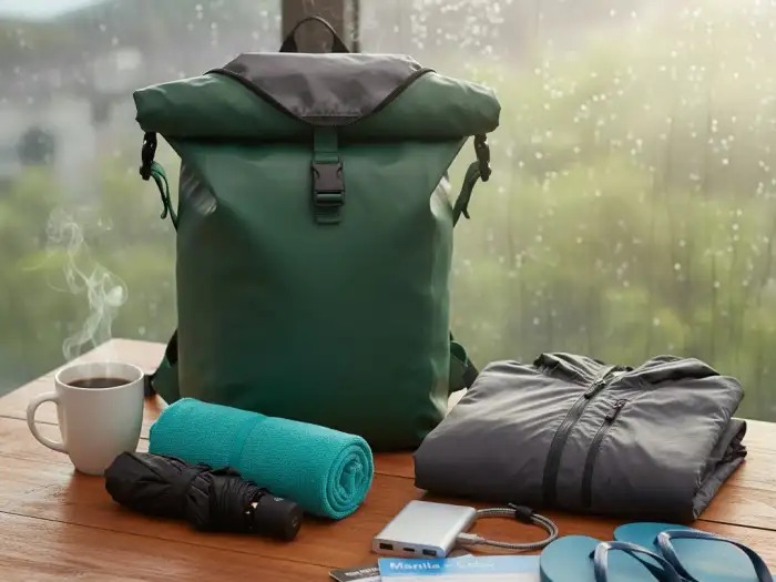 philippines rainy season packing essentials Rainy season travel essentials laid out including rain jacket, umbrella, and backpack.