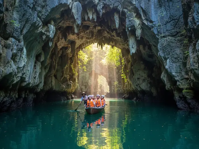 sohoton cove entrance cave lagoon adventure Tourists entering the limestone cave entrance of Sohoton Cove by paddleboat in Bucas Grande.
